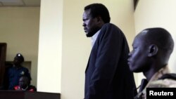 FILE - South Sudanese politician Ezekiel Gatkuoth (C) is seen standing in a courtroom in Juba, March 11, 2014.