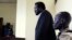 FILE - South Sudanese politician Ezekiel Gatkuoth (C) is seen standing in a courtroom in Juba, March 11, 2014