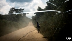 Un homme marche sur la route qui relie la ville de Bunia à la ville minière de Mambasa, dans la province de l’Ituri, le 10 juillet 2018.