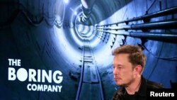 FILE - Elon Musk arrives to speak at Boring Company community meeting in Bel Air, Los Angeles, California, May 17, 2018. 