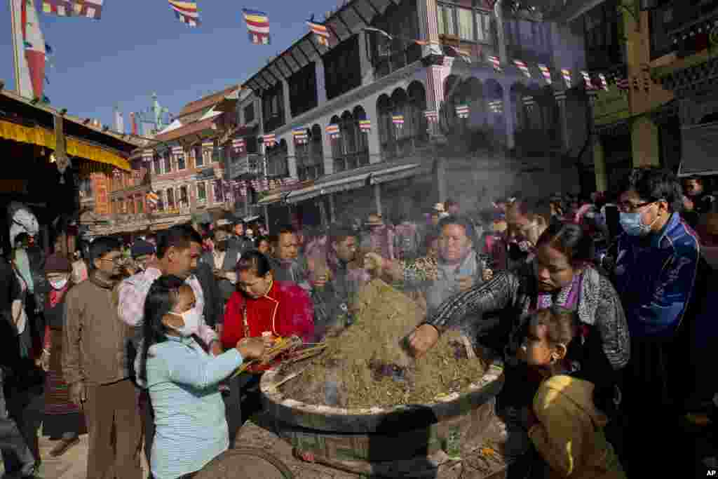 Nepalese Buddhists light incense sticks at the Boudhanath Stupa during Buddha Jayanti, or Buddha Purnima, festival in Kathmandu, May 4, 2015.&nbsp;