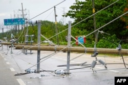 Power line towers lie on the road after being damaged by strong wind gusts caused by the passage of Tropical Storm Beryl in Tulum, Quintana Roo State, Mexico, on July 5, 2024.