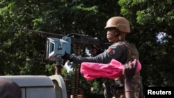 FILE: New junta's soldiers stand guard in an armored vehicle in Ouagadougou, Burkina Faso. taken Oct. 2, 2022.