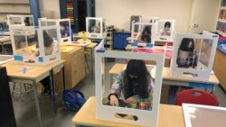 In this March 2, 2021, file photo, socially distanced and with protective partitions students work on an art project during class at the Sinaloa Middle School in Novato, Calif. (AP Photo/Haven Daley, File)