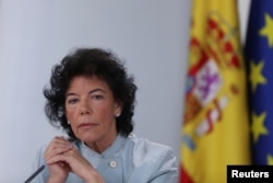 FILE - Spain's Isabel Celaa gestures during a news conference after a cabinet meeting at the Moncloa Palace in Madrid, Spain, June 8, 2018.