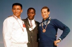 FILE - This Sept. 6, 1960, photo shows the top three finishers in the decathlon of the 1960 Rome Summer Olympics at Olympic Stadium in Rome: Rafer Johnson, Yang Chuan and Vasili Kuznetsov.