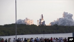 Media capture the launch of space shuttle Endeavour on the STS-134 mission to the International Space Station from the Press Site at NASA's Kennedy Space Center in Florida. The shuttle and its six-member crew lifted off on time at 8:56 a.m. EDT on May 16.