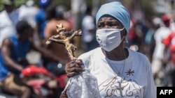 FILE - Haitian protesters march through the streets on Feb. 28, 2021, in Port-au-Prince, to denounce the upsurge in kidnappings committed by gangs.