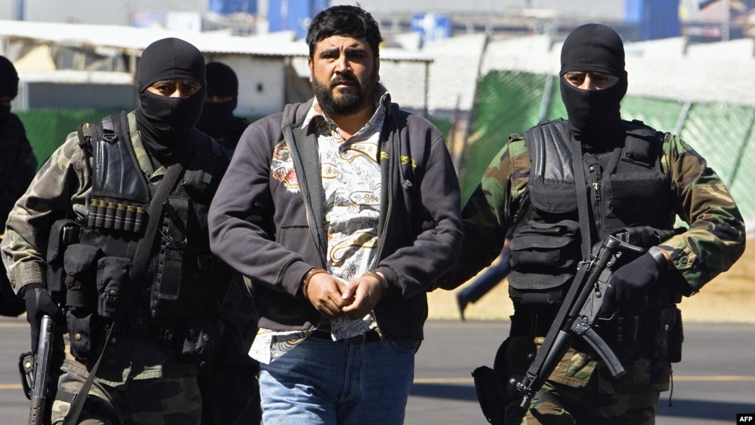FILE - Alleged drug dealer Alfredo Beltran Leyva (C) is showed to the media by members of the Mexican Army in Mexico City, Jan. 21, 2008, after being captured in Culiacan, in the northwestern state of Sinaloa, along with three other members of his gang.