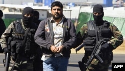 FILE - Alleged drug dealer Alfredo Beltran Leyva (C) is showed to the media by members of the Mexican Army in Mexico City, Jan. 21, 2008, after being captured in Culiacan, in the northwestern state of Sinaloa, along with three other members of his gang.