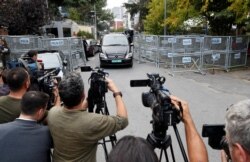 FILE - Journalists are seen during a stake-out in Istanbul, Turkey, Oct. 31, 2018.