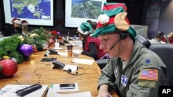 Air Force Lt. Col. David Hanson, of Chicago, takes a phone call from a child in Florida at the Santa Tracking Operations Center at Peterson Air Force Base near Colorado Springs, Colorado, December 24, 2010.