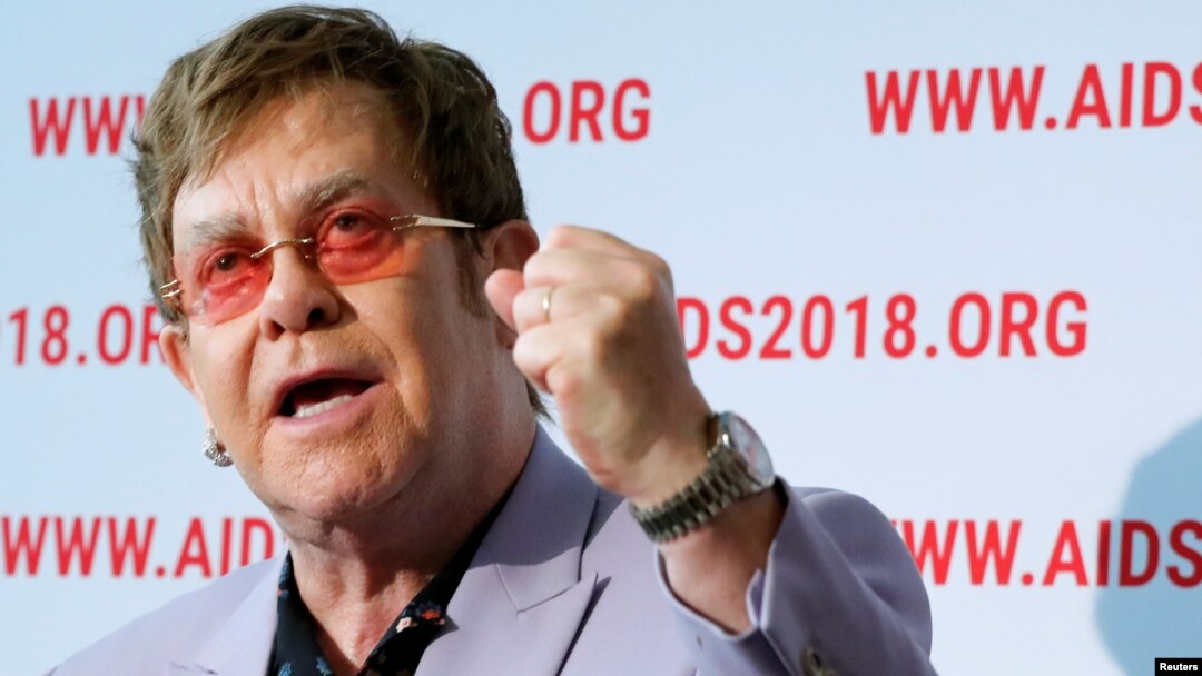 British musician Elton John raises his fist as he delivers a news conference at the 22nd International AIDS Conference (AIDS 2018), the largest HIV/AIDS-focused meeting in the world, in Amsterdam, Netherlands, July 24, 2018.