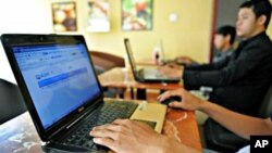 Cambodians using Internet at a coffee shop, in Phnom Penh.