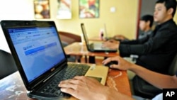 Cambodian men using the Internet at a coffee shop in Phnom Penh.