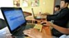 Cambodian men using the Internet at a coffee shop in Phnom Penh.