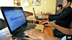 Cambodian men using the Internet at a coffee shop in Phnom Penh.