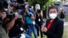 FILE - Rappler CEO Maria Ressa stands in front of reporters outside the Court of Tax Appeals in Manila, Philippines, March 4, 2021. 