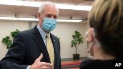 Sen. Ron Johnson, R-Wis., answers reporters after leaving the Senate floor, Jan. 26, 2021, on Capitol Hill in Washington. Johnson asked, “Why are we doing this? I can’t think of something more divisive …” 