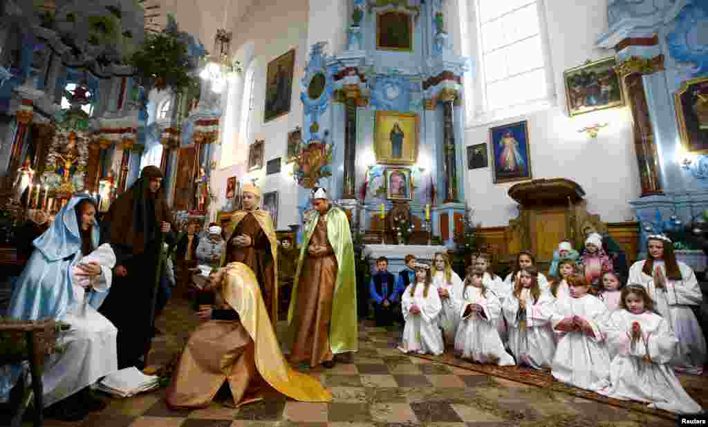 Belarusian children perform in a Catholic church in the town of Dyatlovo, Belarus, Dec. 25, 2017.
