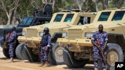 FILE - African Union (AU) soldiers stand with their armored vehicles near a checkpoint in Mogadishu, Somalia, Feb. 7, 2017. 