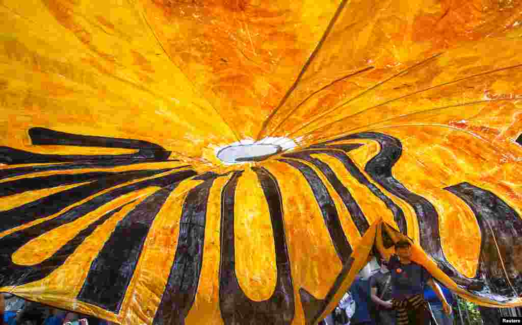 Activist Gloria Fallon, from Chicago, holds a parachute banner which reads 'Justice' while taking part in the Flood Wall Street demonstration in Lower Manhattan, New York. Hundreds of protesters assembled in New York City's financial district, with some planning to risk arrest during an unsanctioned blockade on Wall Street to call attention to what organizers say is capitalism's contribution to climate change. 