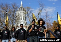 In this 2015 photo, graduate student and member of a black student group Jonathan Butler, center, speaks to a crowd during a demonstration at the University of Missouri.