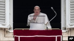 Pope Francis delivers his blessing as he recites the Angelus noon prayer from the window of his studio overlooking St.Peter's Square, at the Vatican, Jan. 19, 2025.