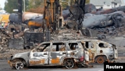 Burned cars are seen near the site of the oil tanker explosions in Lac Megantic, Quebec, July 9, 2013.