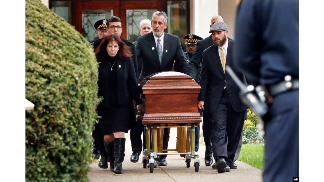 Pittsburgh police stand guard as the casket of Irving Younger, 69, is wheeled from Congregation Rodef Shalom after his funeral on Oct. 31, 2018, in Pittsburgh.