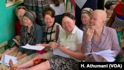 Women living with albinism attend a class at Women and Children with Albinism on the outskirts of Kampala, Uganda, to learn how to make organic soap as a means of earning a living.