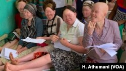 Women living with albinism attend a class at Women and Children with Albinism on the outskirts of Kampala, Uganda, to learn how to make organic soap as a means of earning a living.