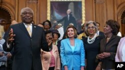 From left, Majority Whip James Clyburn, D-S.C., Speaker of the House Nancy Pelosi, D-Calif., Rep. Joyce Beatty, D-Ohio, and Rep. Maxine Waters, D-Calif., and members of the Congressional Black Caucus celebrate the passage of the Juneteenth Act.