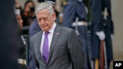 FILE - Defense Secretary Jim Mattis waits for Chinese Minister of Defense General Wei Fenghe to begin an arrival ceremony at the Pentagon, Nov. 9, 2018.