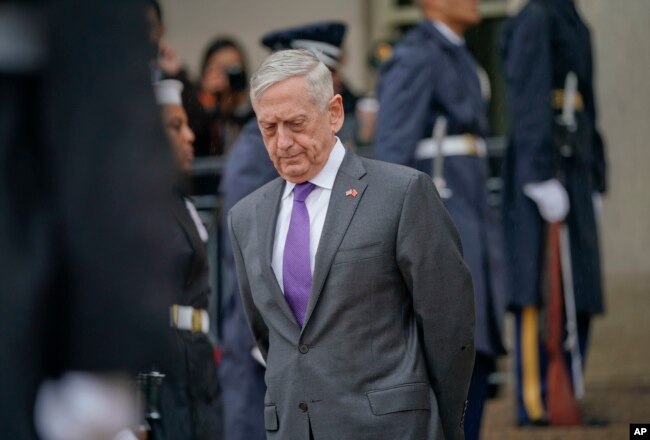 FILE - Then-Defense Secretary Jim Mattis waits for Chinese Minister of Defense General Wei Fenghe to begin an arrival ceremony at the Pentagon, Nov. 9, 2018.
