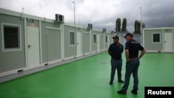 Italian police officers stand at a camp for illegal migrants in Gjader, Albania, Oct. 11, 2024. 