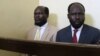 FILE - Kerbino Wol, a businessman, and Peter Biar Ajak, the South Sudan country director for the London School of Economics International Growth Centre based in Britain, sit inside the courtroom in Juba, South Sudan, March 21, 2019.