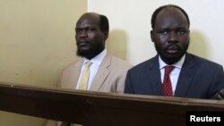 FILE - Kerbino Wol, a businessman, and Peter Biar Ajak, the South Sudan country director for the London School of Economics International Growth Centre based in Britain, sit inside the courtroom in Juba, South Sudan, March 21, 2019.