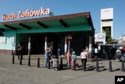 Families wait for a word about miners who have gone missing after a tremor at the Zofiowka coal mine in Jastrzebie-Zdroj in southern Poland, May 5 , 2018.