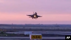 In this video image released by the Egyptian Defense Ministry, an Egyptian fighter jet lands in Egypt, Feb. 16, 2015.