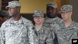Army Private First Class Bradley Manning (C) is escorted out of a courthouse in Fort Meade, Maryland, December 21, 2011.