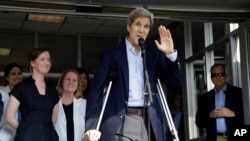 U.S. Secretary of State John Kerry waves after speaking to reporters as he is discharged from Massachusetts General Hospital in Boston, June 12, 2015.