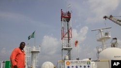 FILE—A member of Shell staff on the Bonga offshore oil Floating Production Storage and Offloading vessel off the coast of the Niger Delta in Nigeria, on December 26, 2011