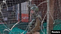 FILE - An Indian policeman stands guard outside a bunker alongside a road in Srinagar Oct. 31, 2019. 