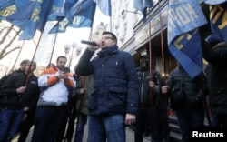 Activists hold a rally to demand a corruption investigation involving officials of Ukraine's defense procurement sector, near the Prosecutor General's Office in Kyiv, Ukraine, Feb. 27, 2019.