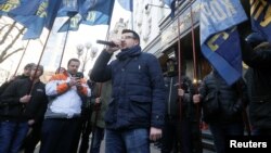 Activists hold a rally to demand a corruption investigation involving officials of Ukraine's defense procurement sector, near the Prosecutor General's Office in Kyiv, Ukraine, Feb. 27, 2019.