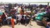 People displaced from fighting between the South Sudanese army and rebels, wait for boats to cross the Nile River, in Bor, around 180 km (112 miles), northwest from the capital of Juba, Dec. 30, 2013. 