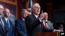 Republican Representative Andy Biggs of Arizona joins a group of conservative Republicans to talk about the interim spending bill being crafted to avoid a shutdown of federal agencies, at the Capitol in Washington, Dec. 18, 2024. 