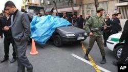 In this photo provided by the International Iran Photo Agency, Iranian security forces stand guard around the site of an explosion outside a university in Tehran, Iran, Wednesday, Jan. 11, 2012.