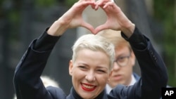 FILE – Belarus opposition activist Maria Kolesnikova gestures on the way to the Belarusian Investigative Committee in Minsk, Belarus, on Aug. 27, 2020. 